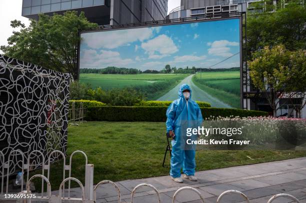 Security guard wears full PPE to protect against the spread of COVID-19 at a testing site in Chaoyang District on April 25, 2022 in Beijing, China....