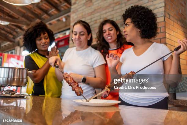 women having barbecue after soccer game - garlic bread stock pictures, royalty-free photos & images