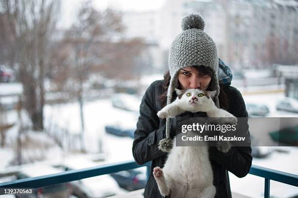 girl playing with her cat - cat and people snow stock pictures, royalty-free photos & images
