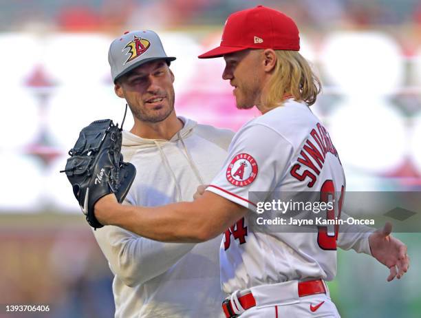 Ryan Getzlaf of the Anaheim Ducks shakes hands with Noah Syndergaard of the Los Angeles Angels after throwing out the first pitch before the game...