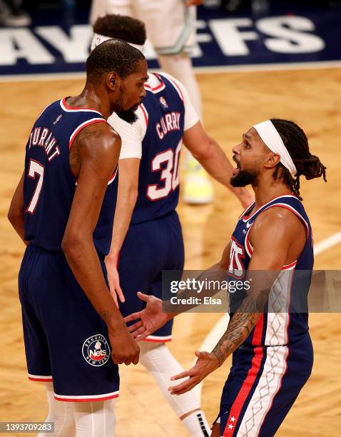 Kevin Durant and Patty Mills of the Brooklyn Nets talk in the first half against the Boston Celtics during Game Four of the Eastern Conference First...