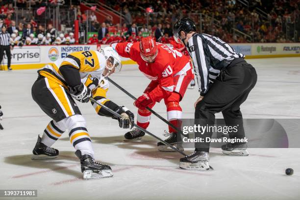 Joe Veleno of the Detroit Red Wings faces off against Sidney Crosby of the Pittsburgh Penguins during the first period of an NHL game at Little...