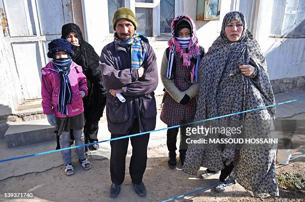 Afghanistan-unrest-refugees-Iran,FEATURE by Claire Truscott An Afghan returnee family looks on after arriving from the Iranian border to the Ansar...