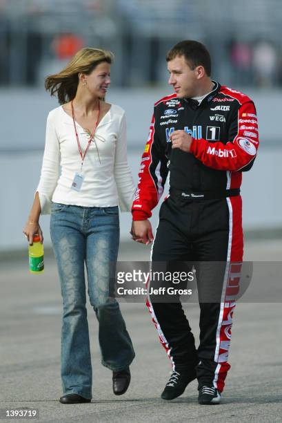 Ryan Newman walks down pit row with his girlfriend Krissie Boyle during qualifying for the NASCAR Winston Cup Series New Hampshire 300 on September...