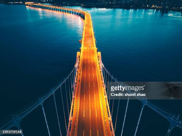aerial view of cross-sea bridge at night - the end concept stock pictures, royalty-free photos & images