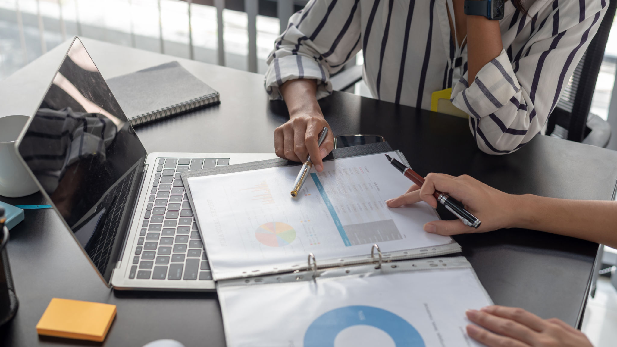 Brainstorming of businesswoman pointing graph and chart analyze financial report at meeting. Brainstorming of businesswoman pointing graph and chart analyze financial report at meeting.