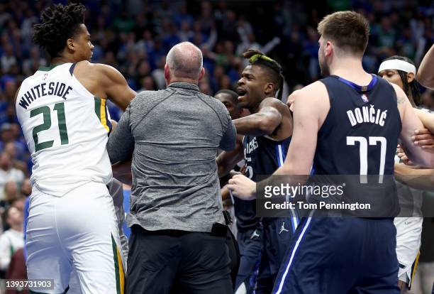 Hassan Whiteside of the Utah Jazz is separated from Reggie Bullock of the Dallas Mavericks after an altercation in the fourth quarter of Game Five of...