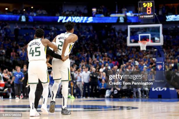 Donovan Mitchell of the Utah Jazz forces Hassan Whiteside of the Utah Jazz off the court after Whiteside was called for two technical fouls and...