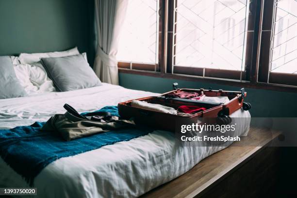 a view of a bedroom with an open luggage on the bed - thailand hotel stock pictures, royalty-free photos & images