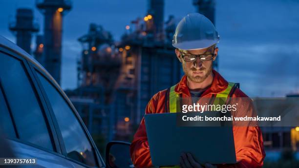 engineer working on outdoor building site at night. - gas engineer stock pictures, royalty-free photos & images