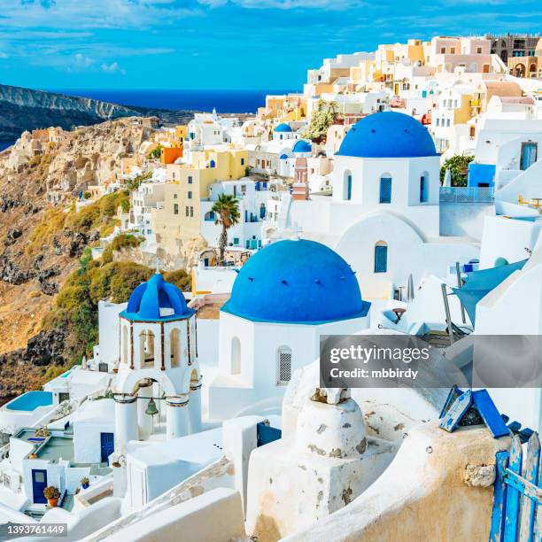 iglesias de agios spyridon y anastasi en el pueblo de oia (ia) en la isla de santorini, grecia - greek islands fotografías e imágenes de stock