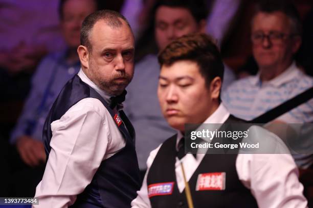 Mark Williams of Wales looks on beside Yan Bingtao of China during the Betfred World Snooker Championship Quarter Final match between Yan Bingtao of...