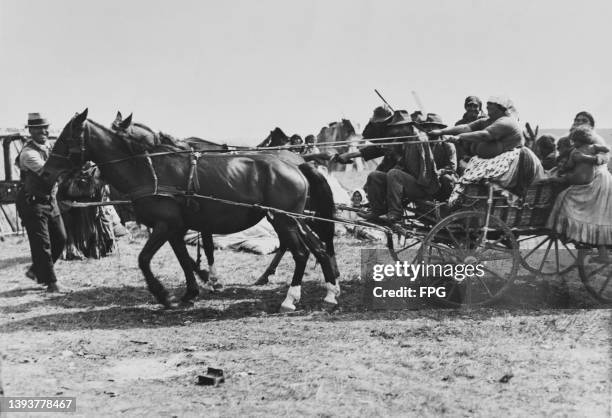 Roma people in a horse and cart as they move on from their camp on the Hungarian Puszta, an area of grassland in the eastern part of Hungary, circa...