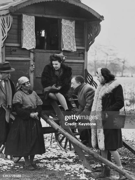 Roma woman Dorothy in conversation with American singer and actor George Britton and his wife, Canadian singer and actress Kaye Connor , British...