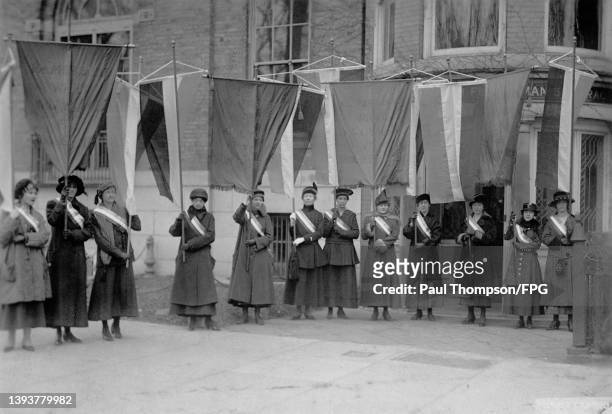 The first suffrage picket line wearing sashes and holding vexilla as they leave the National Woman's Party headquarters in Lafayette Square,...