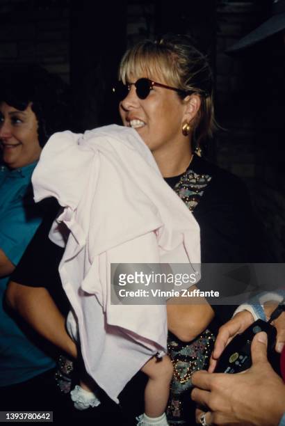 American songwriter Sandy Mahl holding her daughter, August Anna, backstage at Garth Brook's concert date at the Hollywood Bowl in Los Angeles,...