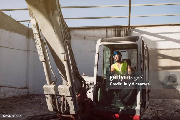 man working with backhoe in construction site - earth mover stock pictures, royalty-free photos & images