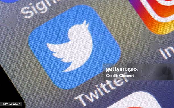 In this photo illustration, the Twitter app logo is displayed on the screen of an iPhone on April 26, 2022 in Paris, France. The U.S....