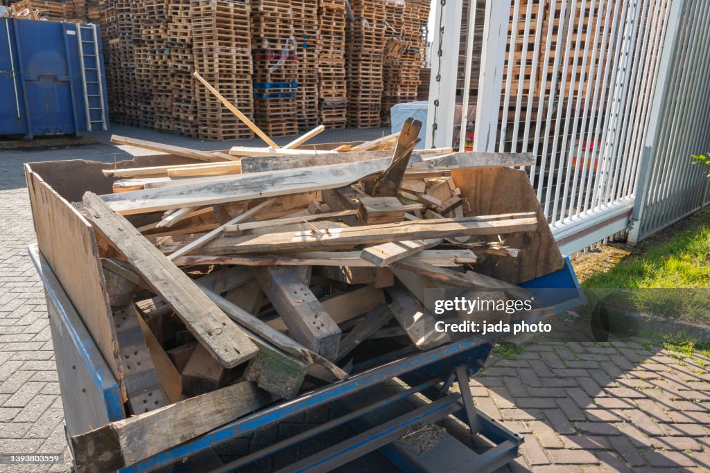 Blue steel container filled with waste wood