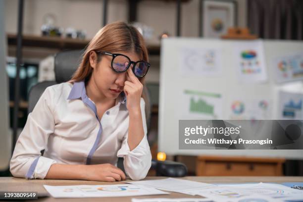 fatigued businesswoman taking off glasses tired of computer work - dry ストックフォトと画像
