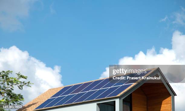 solar panels on the roof of the modern house - panel solar stock pictures, royalty-free photos & images