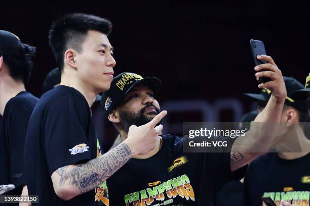 Kyle Fogg and Zhang Zhenlin of Liaoning Flying Leopards celebrate victory after 2021/2022 Chinese Basketball Association League final match between...