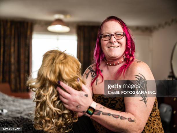 persona transgénero probando peluca nueva - gender fluid fotografías e imágenes de stock