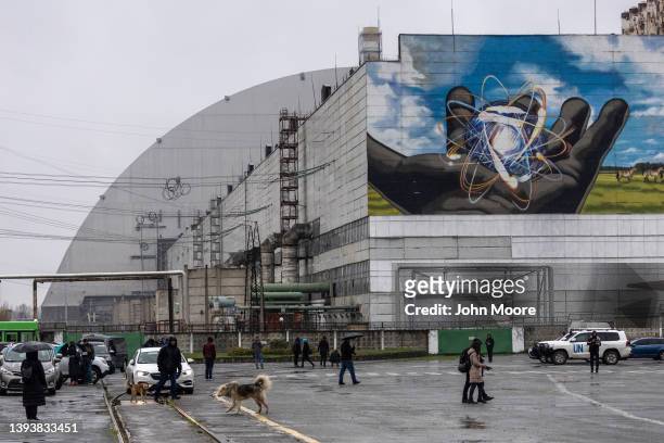 Journalists stand outside the Chernobyl Nuclear Power Plant after staff from the International Atomic Energy Agency arrived at the facility on April...
