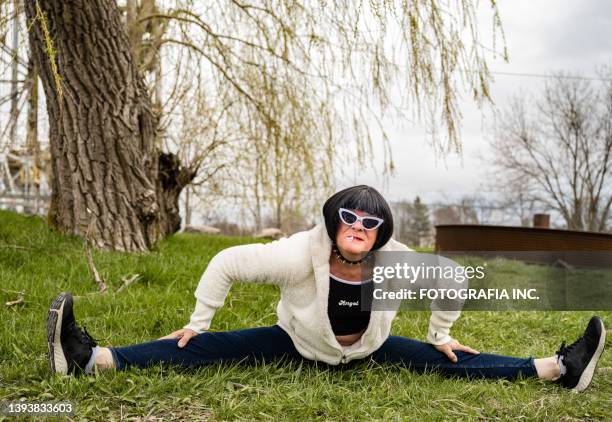 transgender person relaxing outdoors - doing the splits stock pictures, royalty-free photos & images