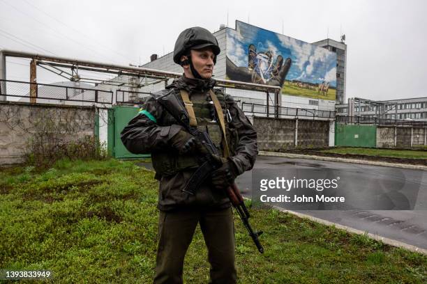 Ukrainian army soldier stands guard at the Chernobyl Nuclear Power Plant on April 26, 2022 in Chernobyl, Ukraine. Staff from the International Atomic...