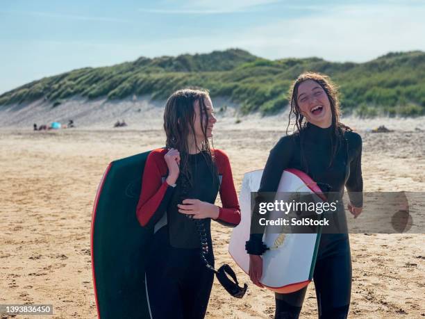 enjoying the day surfing - beach holiday uk stock pictures, royalty-free photos & images