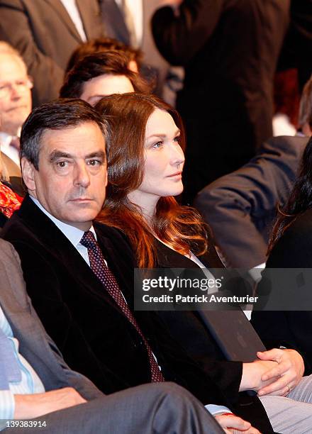 Carla Bruni-Sarkozi listens as French President Nicolas Sarkozy speaks during the UMP presidential support meeting on February 19, 2012 in Marseille,...