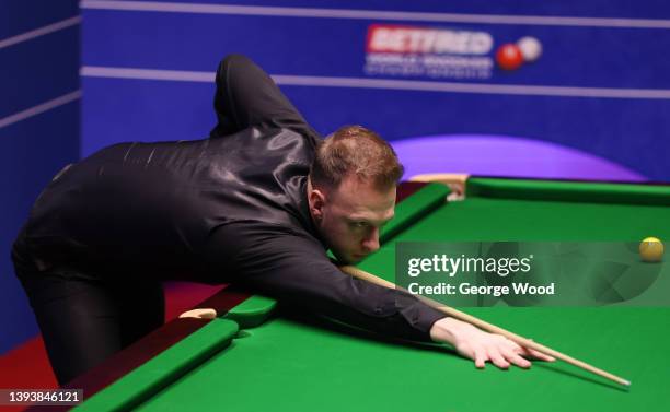 Judd Trump of England plays a shot during the Betfred World Snooker Championship Quarter Final match between Stuart Bingham of England and Judd Trump...