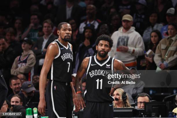 Kevin Durant and Kyrie Irving of the Brooklyn Nets look on in the final seconds of their 109-103 loss against the Boston Celtics during Game Three of...