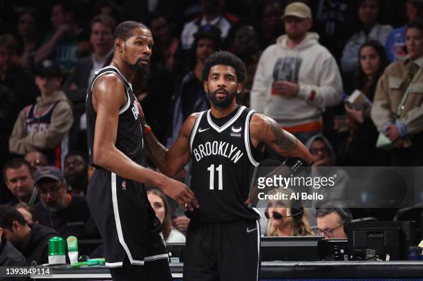 Kevin Durant and Kyrie Irving of the Brooklyn Nets look on in the final seconds of their 109-103 loss against the Boston Celtics during Game Three of...