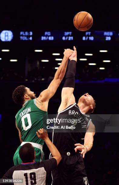 Jayson Tatum of the Boston Celtics and Blake Griffin of the Brooklyn Nets tip off during Game Three of the Eastern Conference First Round NBA...