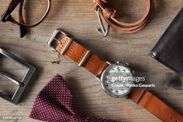 top down image of classic vintage men accessories with bow tie neatly arranged - wristwatch imagens e fotografias de stock
