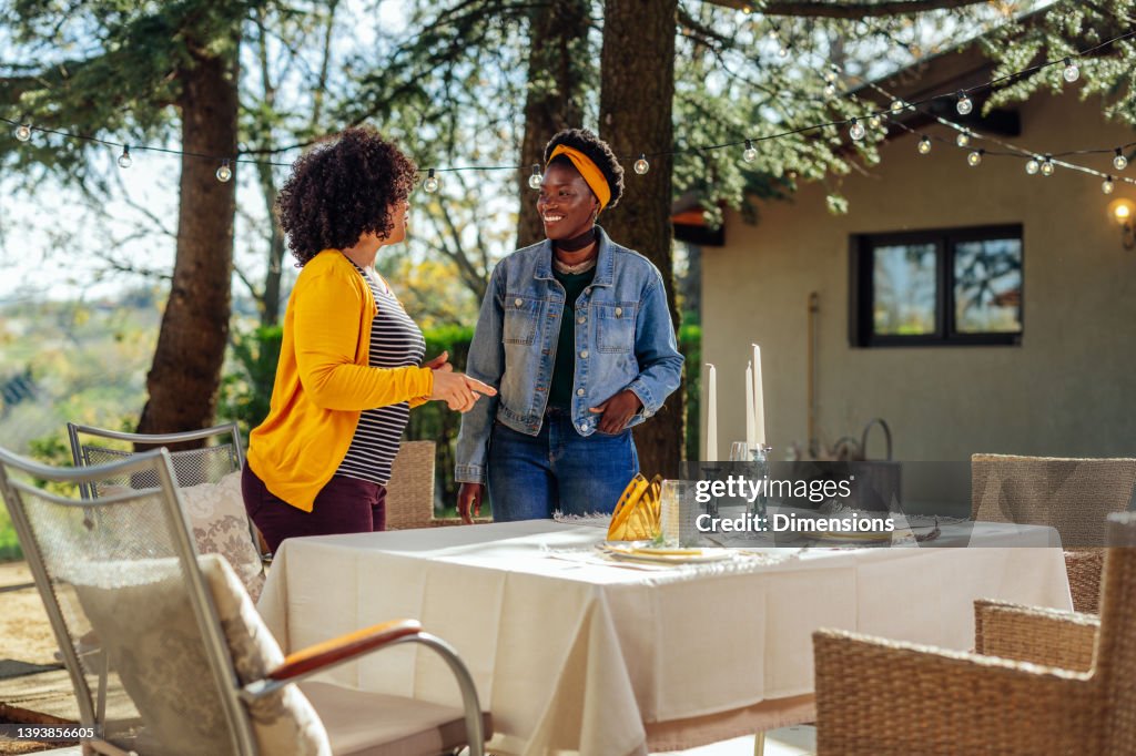 Women setting table for lunch.