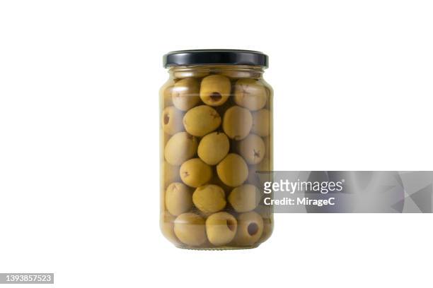 pitted green olives in a glass jar isolated on white - green olive fotografías e imágenes de stock