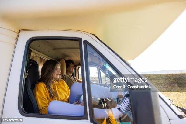 carefree caucasian couple enjoy the journey with their camper van - mini van driving stock pictures, royalty-free photos & images