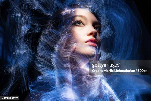 light painting portrait,close-up of young woman with make-up against black background,russia - light painting stock-fotos und bilder