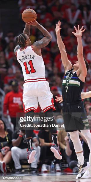 DeMar DeRozan of the Chicago Bulls shoots against Grayson Allen of the Milwaukee Bucks during Game Four of the Eastern Conference First Round...
