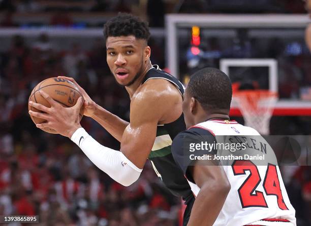 Giannis Antetokounmpo of the Milwaukee Bucks looks to pass against Javonte Green of the Chicago Bulls during Game Four of the Eastern Conference...