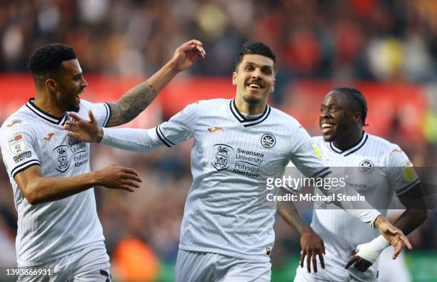 Joel Piroe of Swansea City celebrates after scoring their sides second goal during the Sky Bet Championship match between Swansea City and AFC...