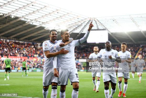 Joel Piroe of Swansea City celebrates with team mate Cyrus Christie after scoring their sides second goal during the Sky Bet Championship match...