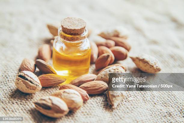 almond essential oil in a small bottle selective focus - almond oil stockfoto's en -beelden