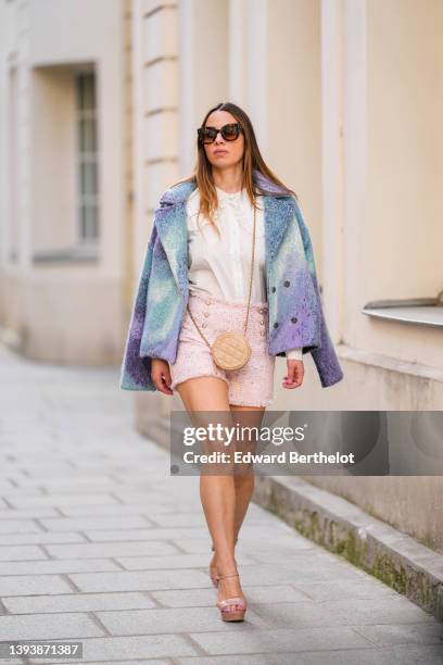 Maria Rosaria Rizzo wears brown sunglasses, a white with lace pattern oversized blouse / shirt from La petite Étoile, a beige shiny leather circle...