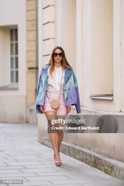 Maria Rosaria Rizzo wears brown sunglasses, a white with lace pattern oversized blouse / shirt from La petite Étoile, a beige shiny leather circle...