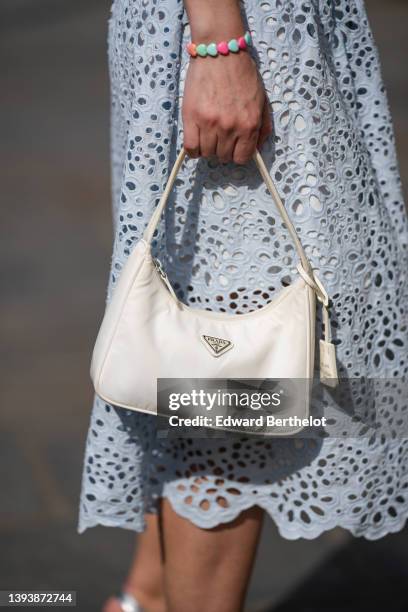 Maria Rosaria Rizzo wears a pale blue cut-out lace pattern midi dress with puffy short sleeves from Maja, a white braided belt from Maja, a silver...