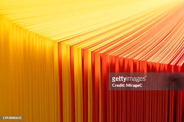 yellow and red gradient paper pages fanned out - aufgefächert stock-fotos und bilder